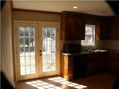 French doors off the kitchen let in lots of natura