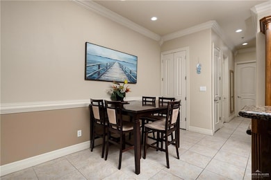 Dining area featuring light tile patterned flooring, ornamental molding, and recessed lighting