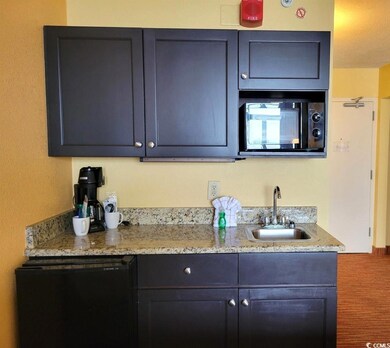 Kitchen featuring light stone countertops, sink, a