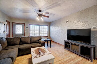 Living room with visible vents, a healthy amount o