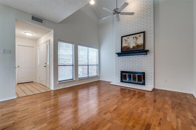 Unfurnished living room featuring ceiling fan, a f