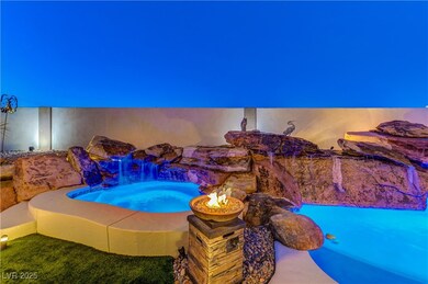 Twilight photo of expansive pool, spa and rock wat