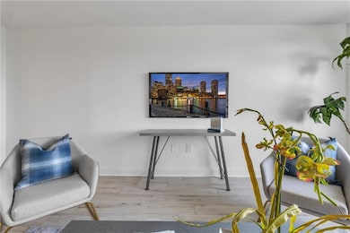 Living area with wood finished floors and baseboards