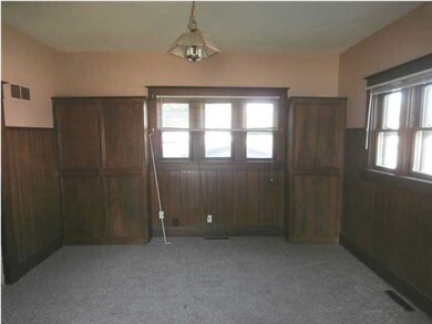 Formal dining room with built in cabinet storage. 
