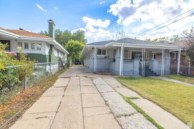 View of front of home featuring a porch, concrete driveway, and roof with shingles