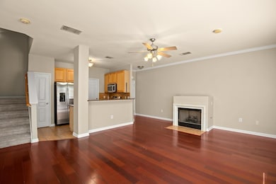 Unfurnished living room featuring ceiling fan, wo