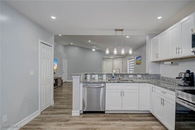Kitchen with dishwasher, a sink, a peninsula, whit