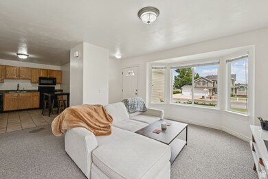 Living area featuring light colored carpet and baseboards