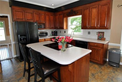 Remodeled Kitchen has new cabinetry, solid surface counters, appliances, flooring