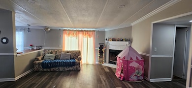 Living area with a brick fireplace, dark wood-type