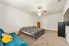 Carpeted bedroom with a ceiling fan