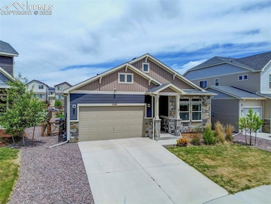 Craftsman-style house with stone siding, board and
