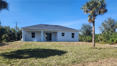 Back of property with a yard