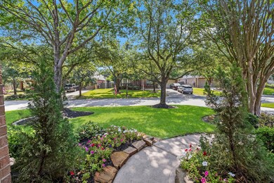 View from underneath the front covered porch looking out to the front yard. Note the well-established oak trees all around.