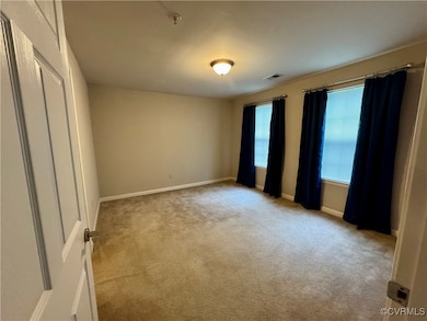 Unfurnished bedroom with carpet flooring and baseb