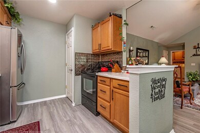 Kitchen has walk in pantry, electric range & oven and open to living room.
