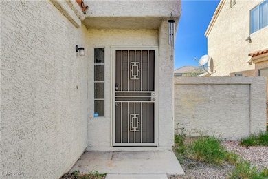 Property entrance with stucco siding