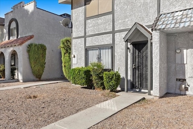 Entrance to property with stucco siding