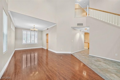 Unfurnished living room featuring a chandelier, cr