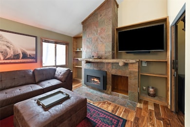 Living room with a gas fireplace, built in feature
