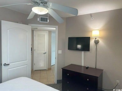 Tiled bedroom with ceiling fan