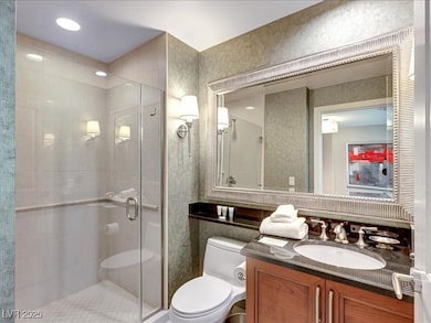 Bathroom featuring a stall shower and vanity