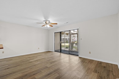 Empty room featuring a ceiling fan, baseboards, an