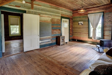 Living area featuring a wood stove, hardwood / wo