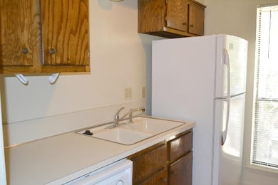 Kitchen with freestanding refrigerator, a sink, br