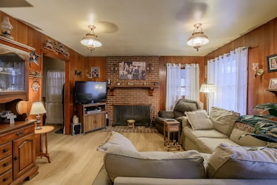 Family room is warmed by a cozy wood-burning, bric