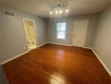 Empty room with baseboards, dark wood-style floors