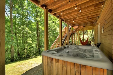 Patio with a hot tub and stairway