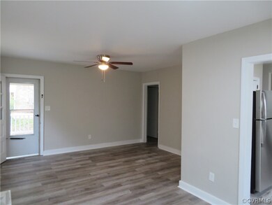 Spare room featuring ceiling fan and hardwood / wo