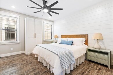 Bedroom featuring dark wood finished floors, mult