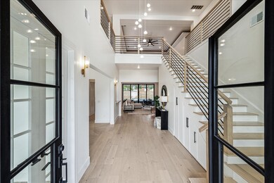 An inviting entryway features striking 8 ft black
