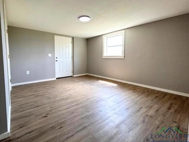 Empty room featuring dark wood finished floors and
