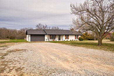 Ranch-style house featuring a garage and a porch