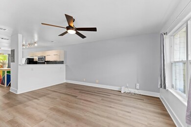 Unfurnished living room featuring a ceiling fan, 