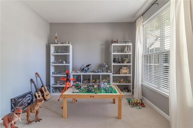 Playroom featuring carpet floors and baseboards