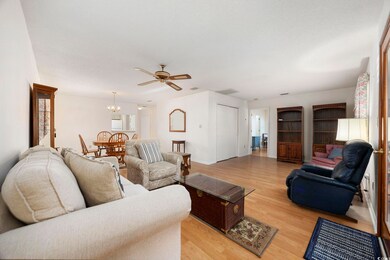 Living room with light wood finished floors, ceili