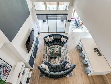 Living room featuring a high ceiling and wood-type
