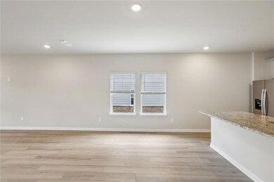 Unfurnished living room with light wood-style floo