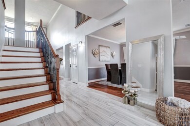 This airy foyer is the perfect welcome to your guests with recently installed wood stair risers and luxurious bamboo flooring.