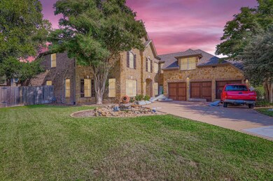View of front of property with driveway, a garage, stone siding, and brick siding