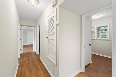 Hall with hardwood / wood-style flooring