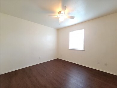 Empty room featuring dark wood finished floors, a