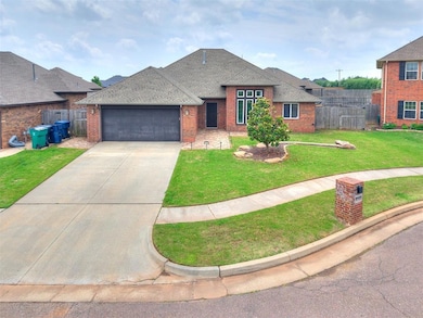View of front of home featuring a garage, brick siding, roof with shingles, and driveway