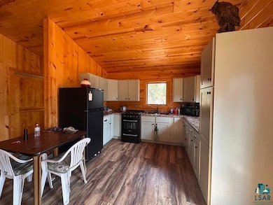 Kitchen featuring black appliances, dark wood fini