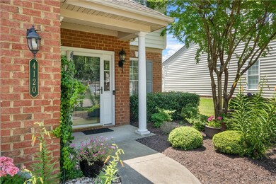 View of exterior entry featuring brick siding