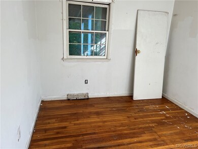 Unfurnished room with dark wood-type flooring